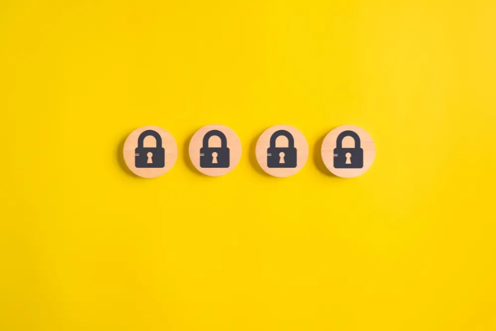 Four wooden tokens with padlock icons on yellow background